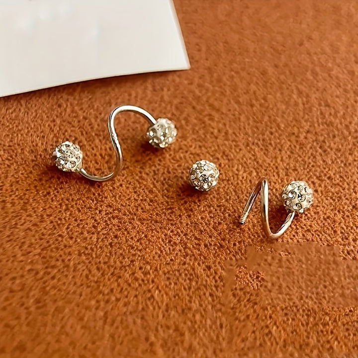 Spirale d’Éclat – Boucles d’oreilles à bille sertie